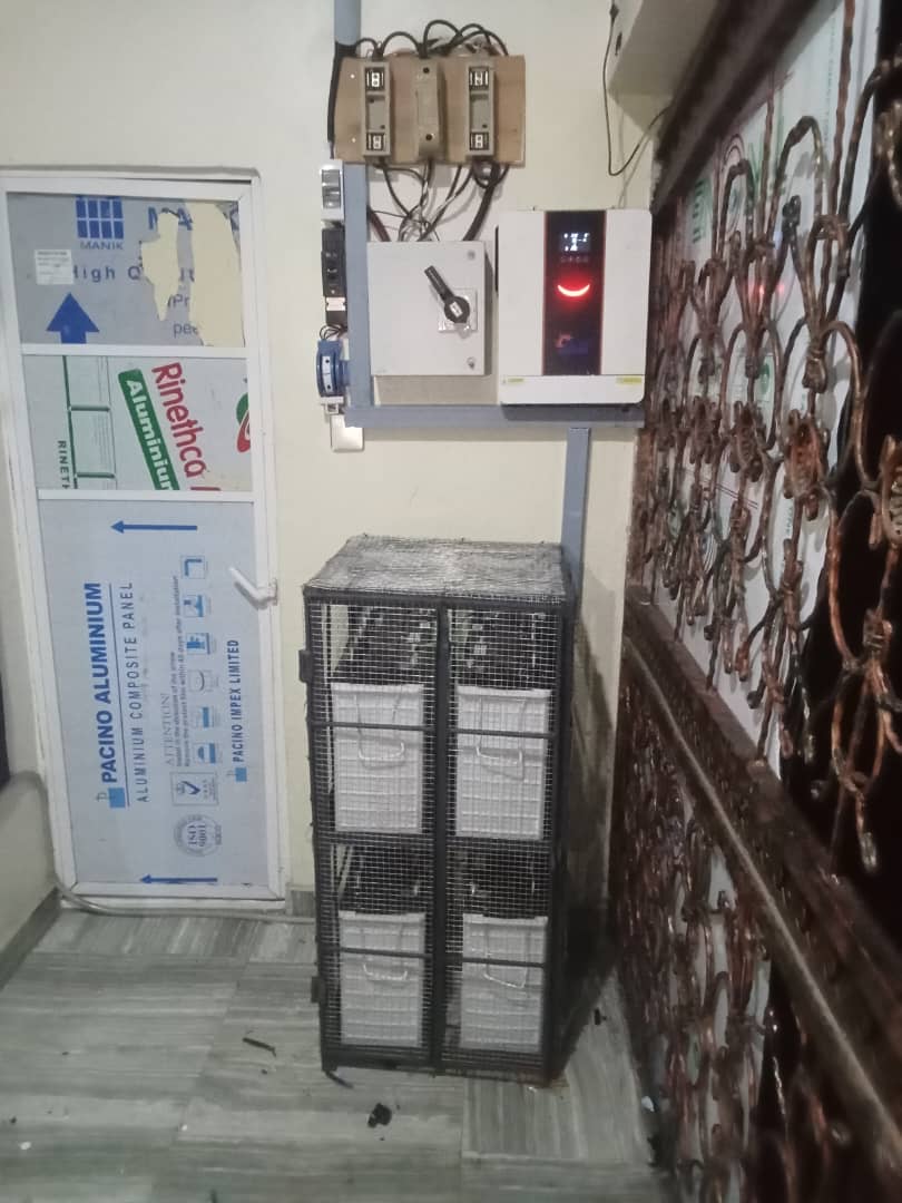 Technician performing maintenance on a solar inverter
